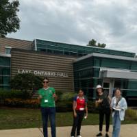 Students posing for a picture outside Lake Ontario Hall at GVSU during orientation
